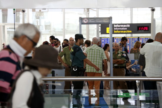 Barcelona airport passengers during a security control in front of a Spanish Guàrdia Civil police officer on August 13, 2017