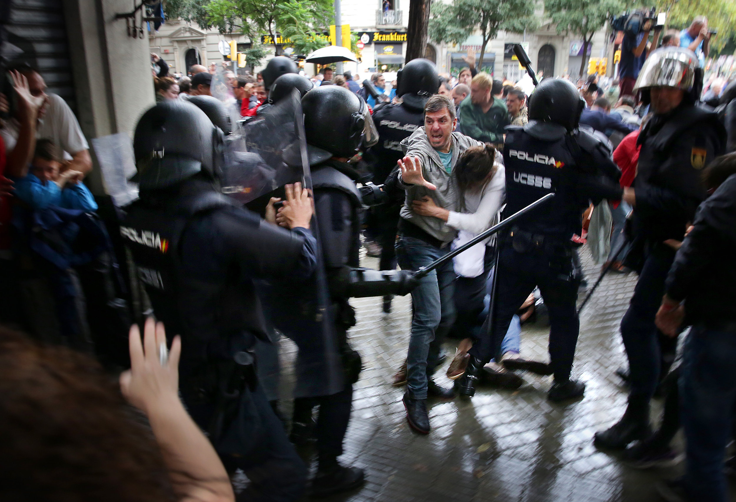 Spanish national police officers confront demonstrators during the 2017 Catalan independence referendum