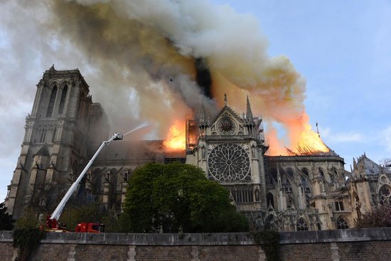 A side picture of Paris Notre Dame Cathedral during a  fire on April 15, 2019