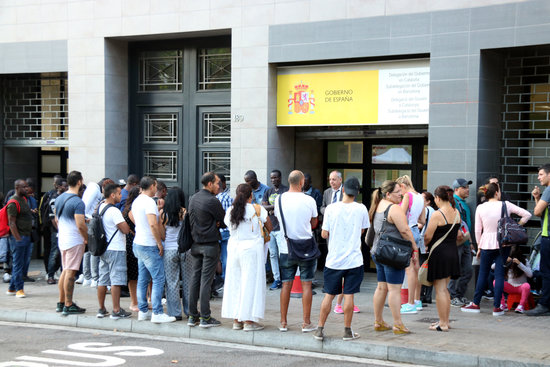 People lining up outside a Spanish immigration office in Barcelona