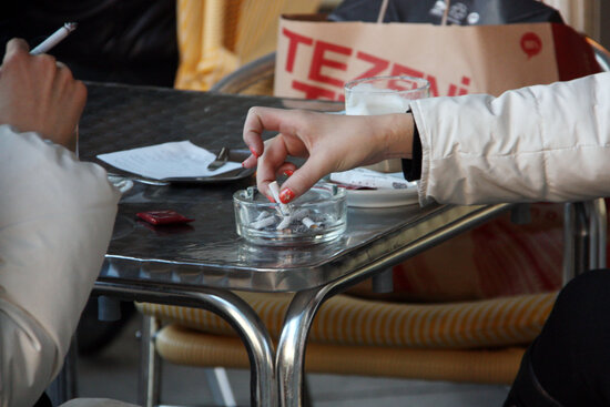 Smokers sitting at a restaurant terrace