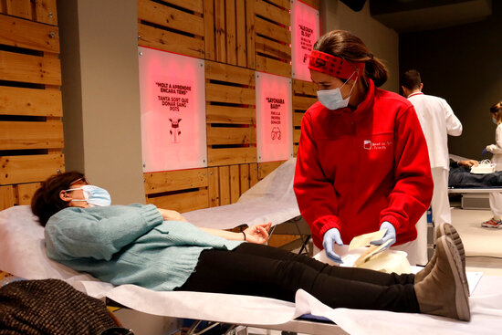 A woman donates blood during the 2020 blood donation drive