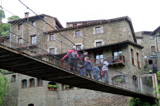 A family crosses the hanging bridge of Rupit on May 23, 2021