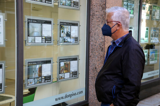 A man looking at apartments for sale