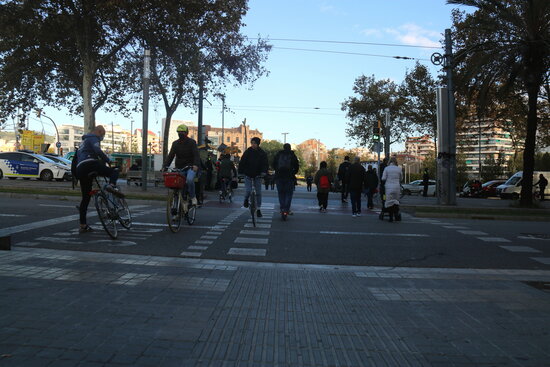 Cyclists and pedestrians crossing the street in Barcelona's Glòries area