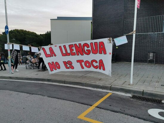 'Don't touch the language' - a poster in favor of Catalan immersion in schools outside Turó del Drac School, Canet de Mar in 2021