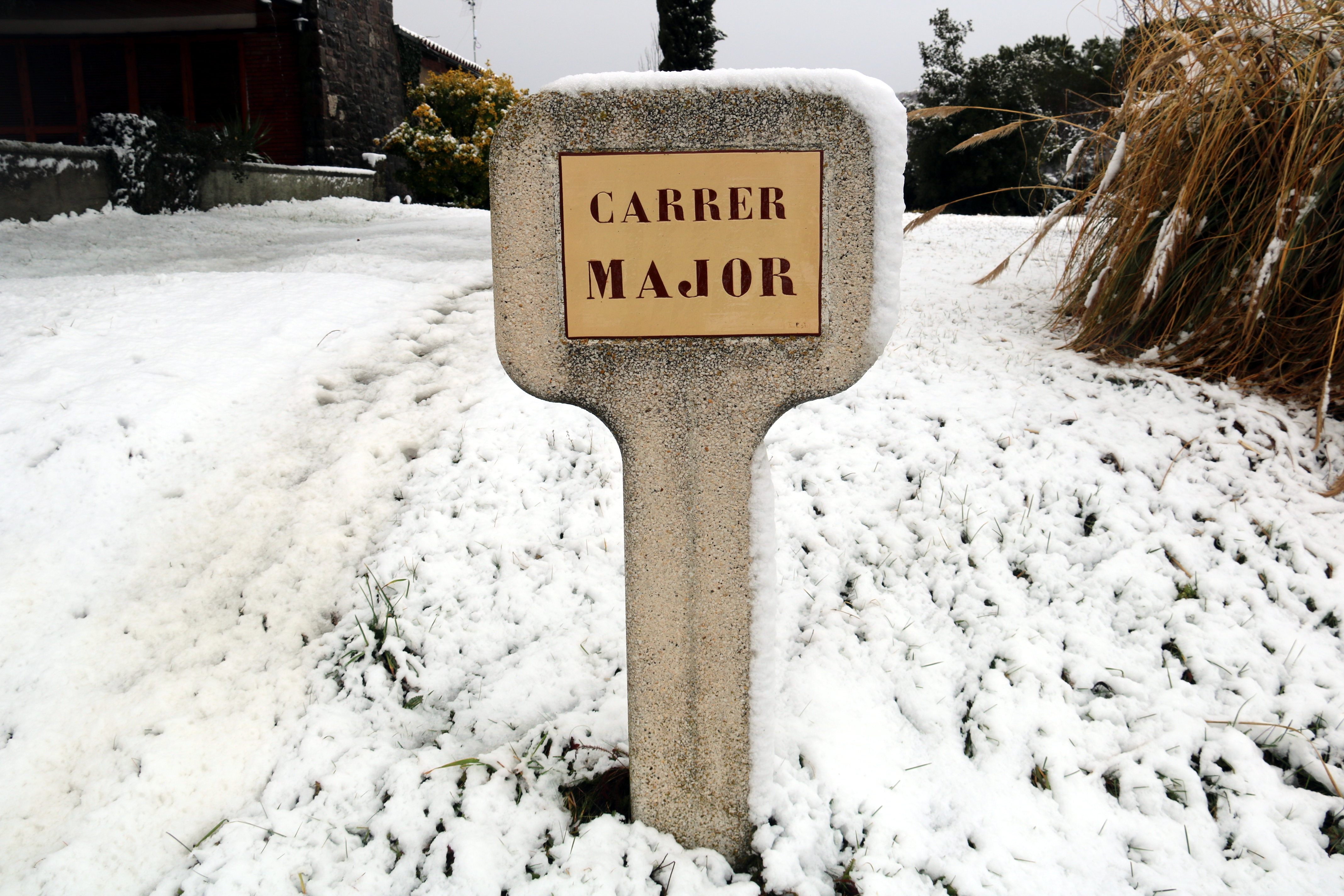 A street sign for Main Street in Collsuspina covered in snow