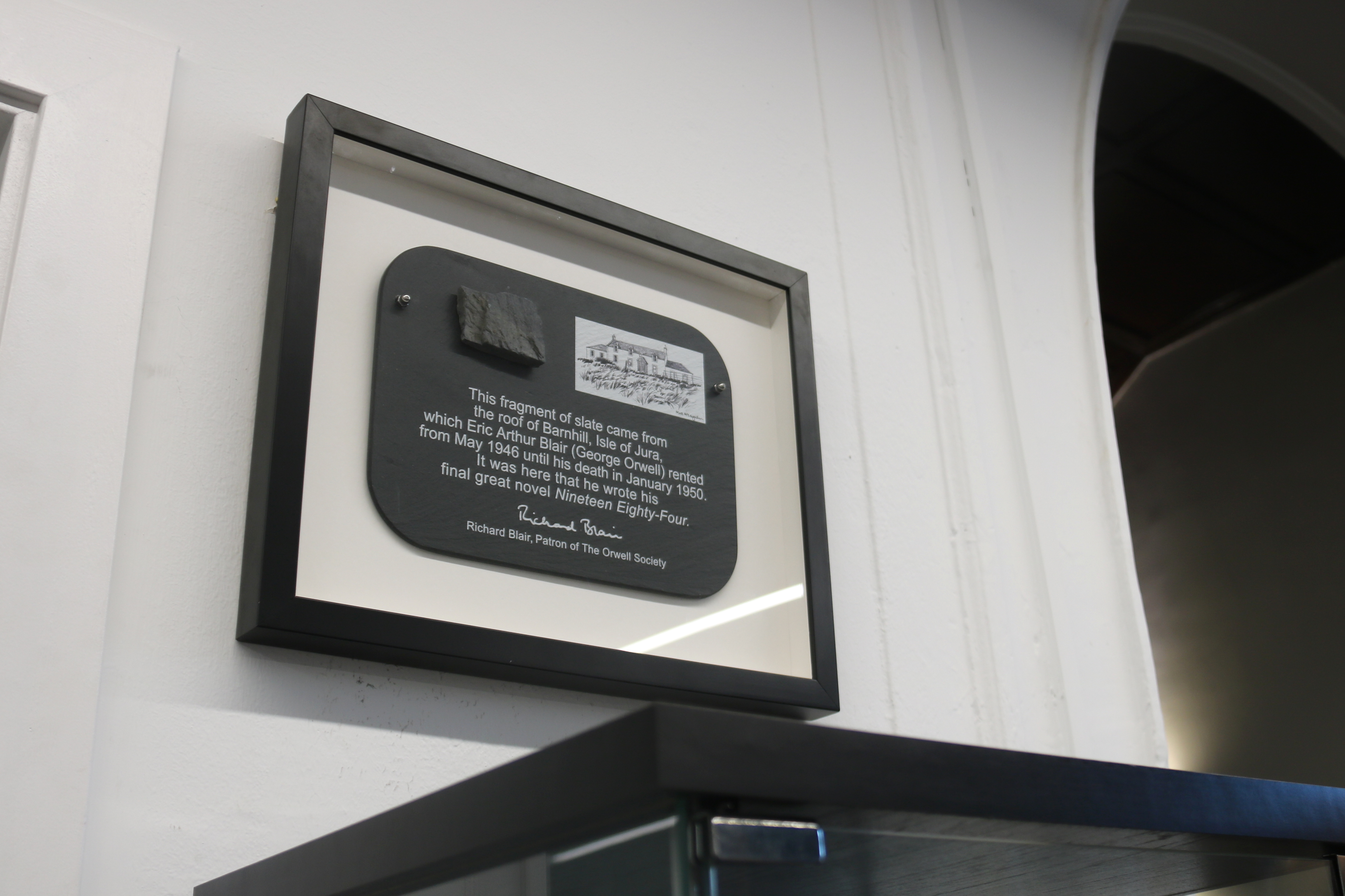 A plaque with a fragment of slate of the house where George Orwell wrote '1984'. The plaque can be found in Barcelona's old Sanatorium Maurí, where the author spent some time, currently Benjamin Franklin international school