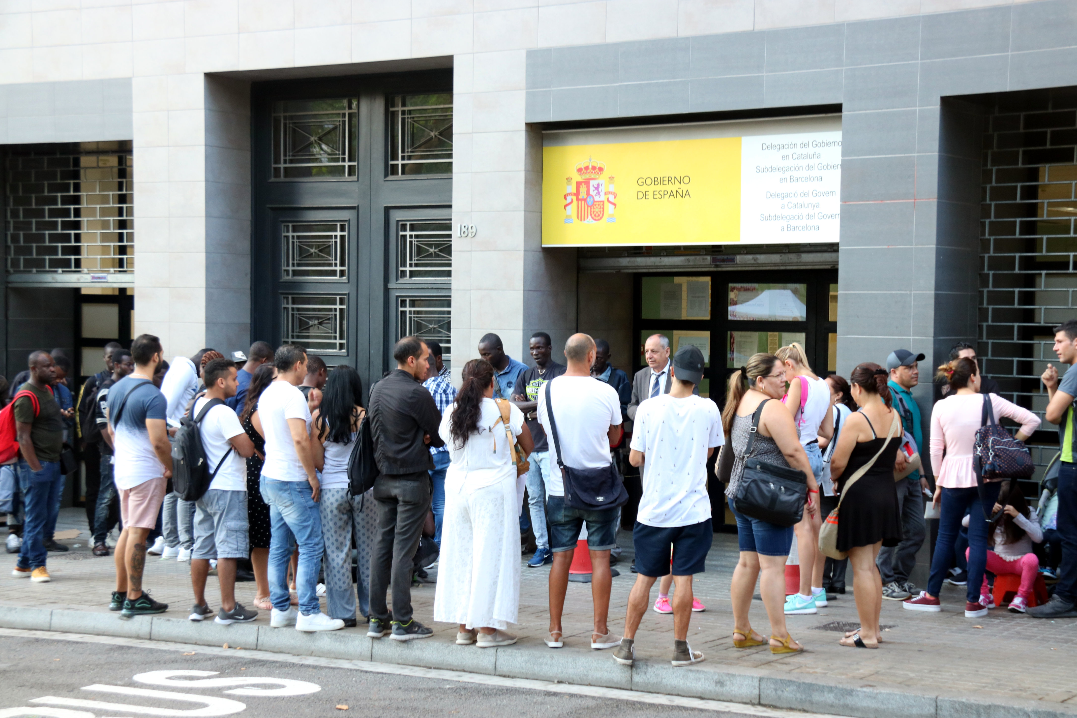 Dozens queue outside an immigration office in Barcelona