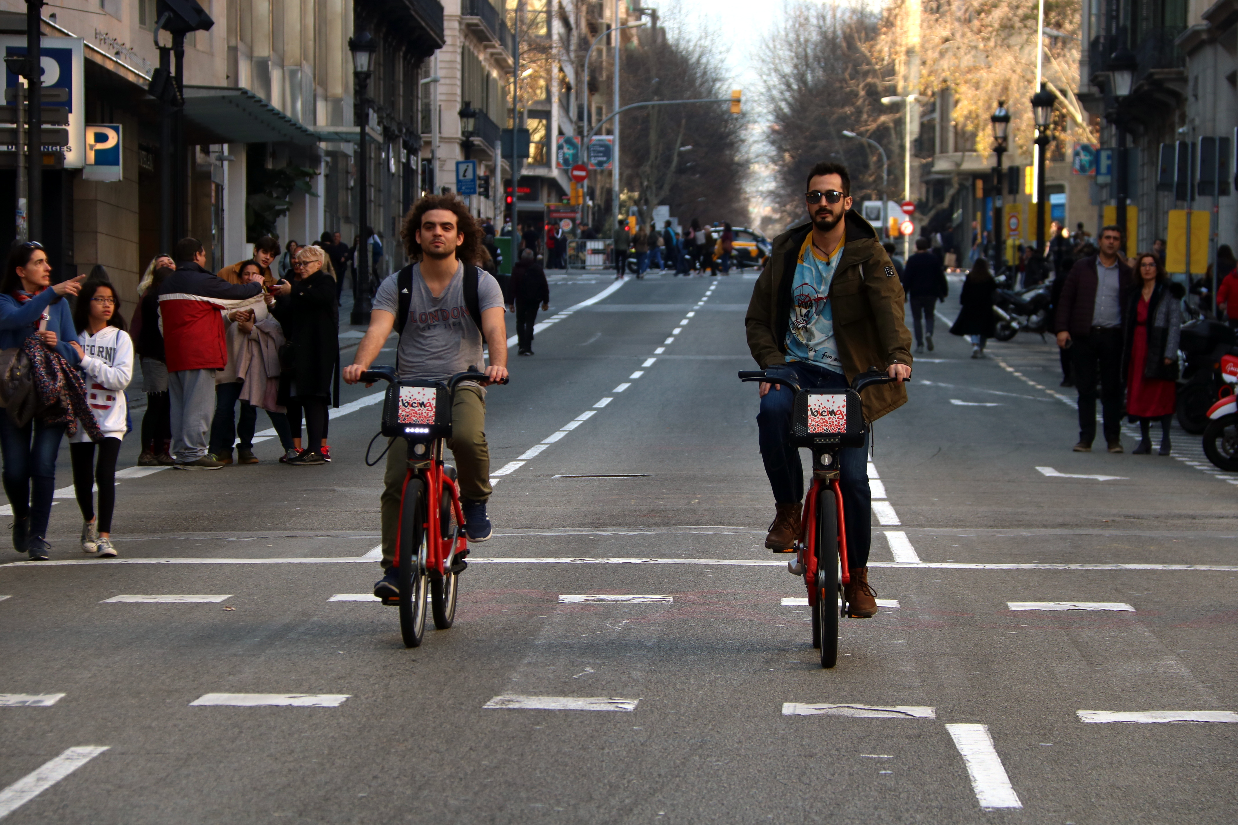 Two Bicing users riding down Via Laietana
