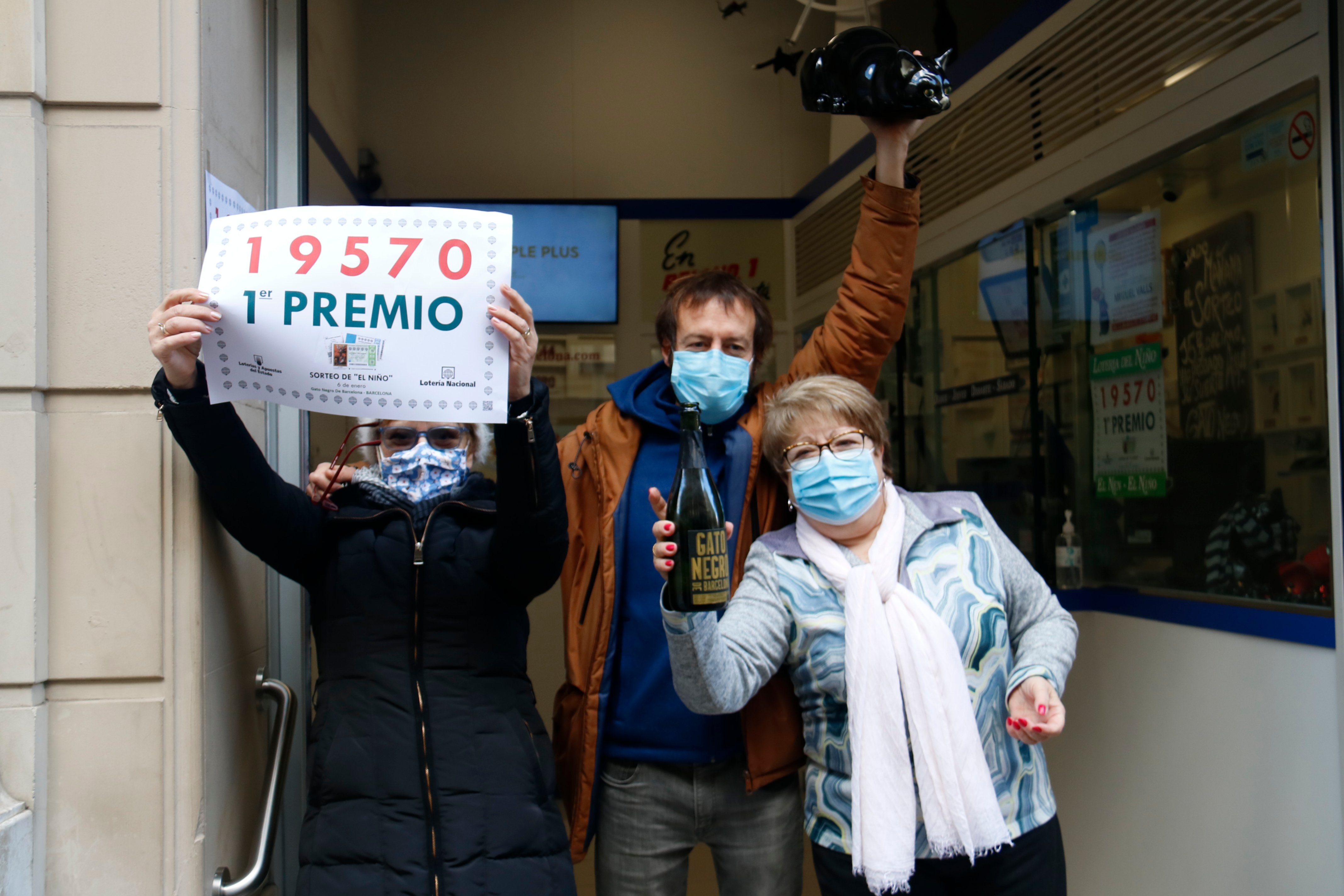 Gato Negro lottery sellers celebrate giving out a prize