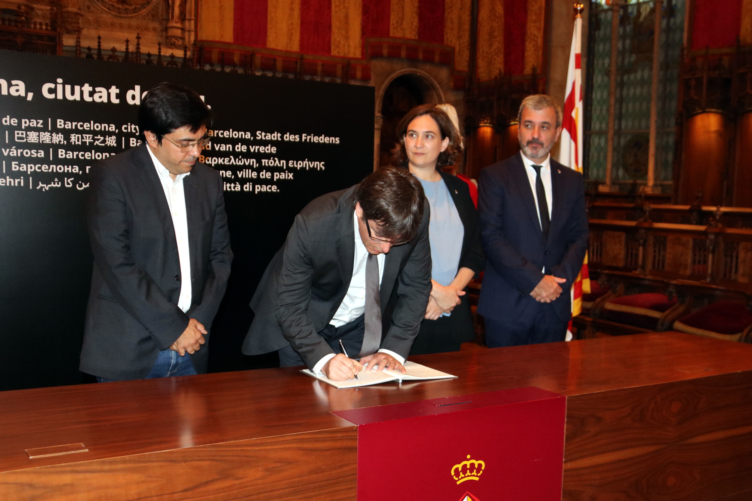 Catalan president, Carles Puigdemont, signing the condolence book in Barcelona city hall