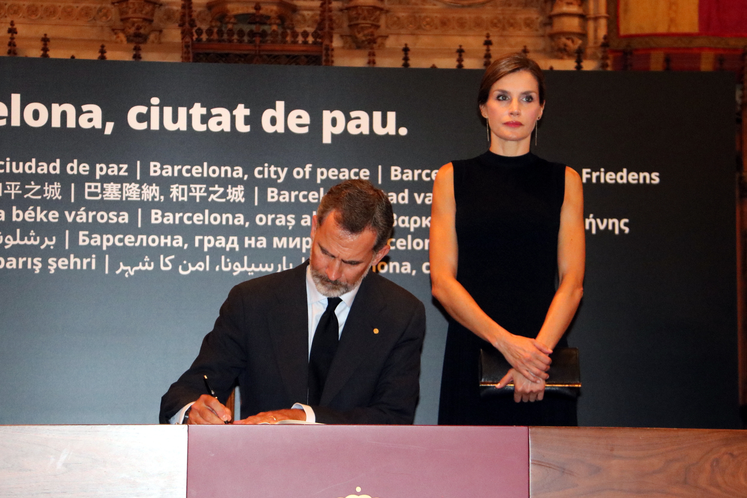The King of Spain, Felipe VI, signs the condolence book next to the Queen Letizia