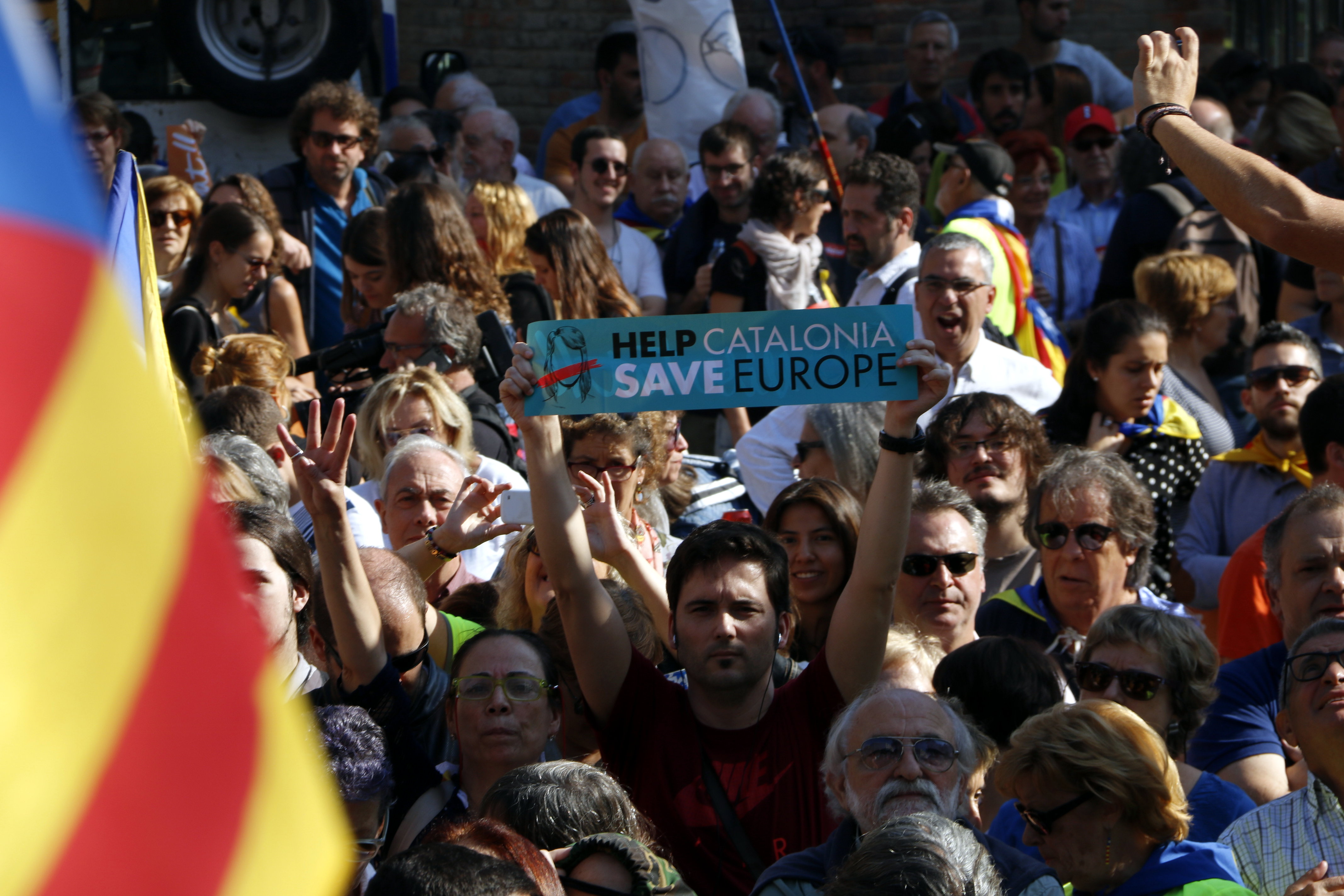 Demonstrator holding a sign that reads “Help Catalonia. Save Europe! (by Laura Busquets)