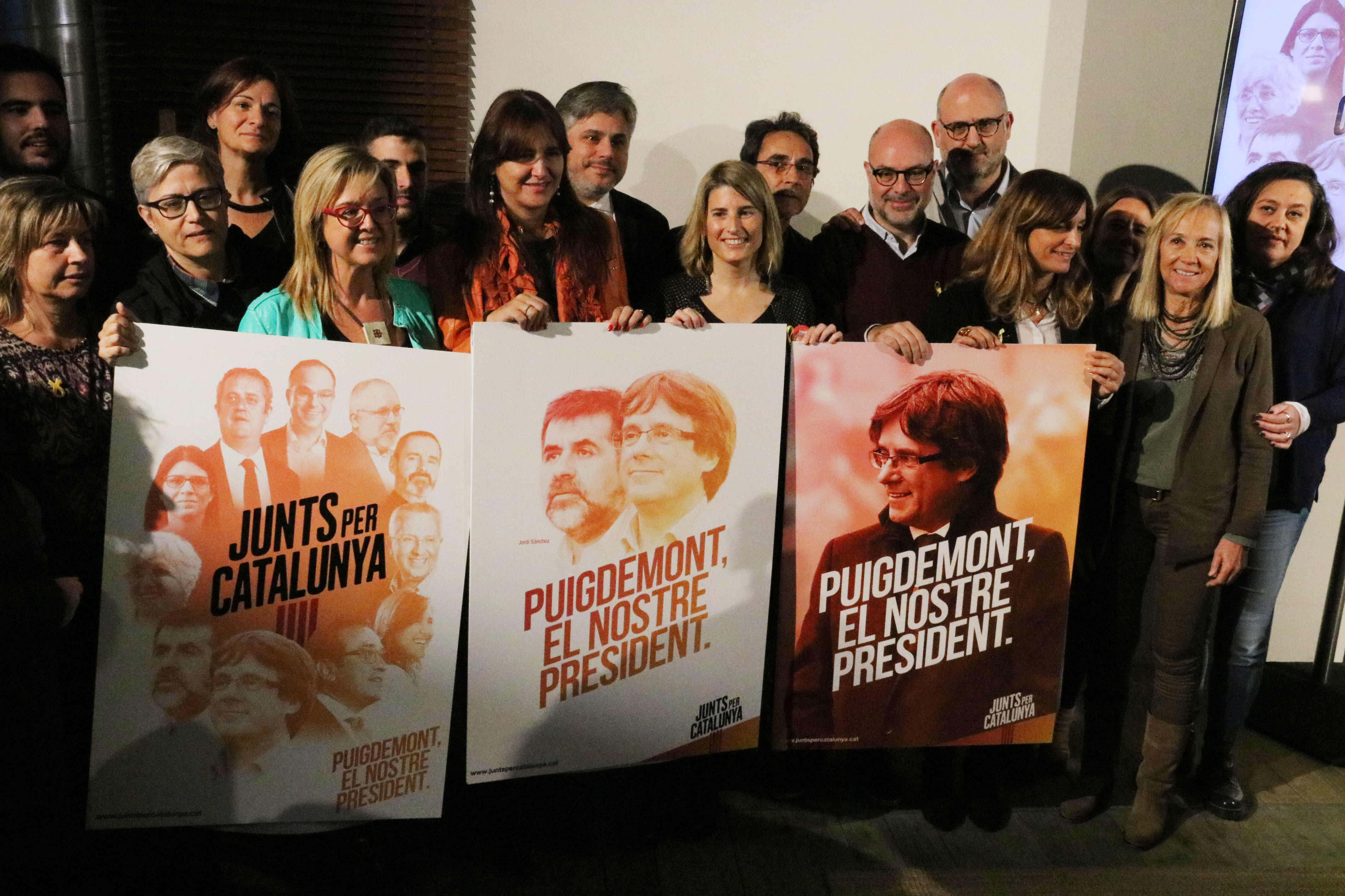 Memebers of the pro-independence Together for Catalonia candidacy pose for a photo with their campaign posters on November 28, 2017 (by Jordi Bataller)