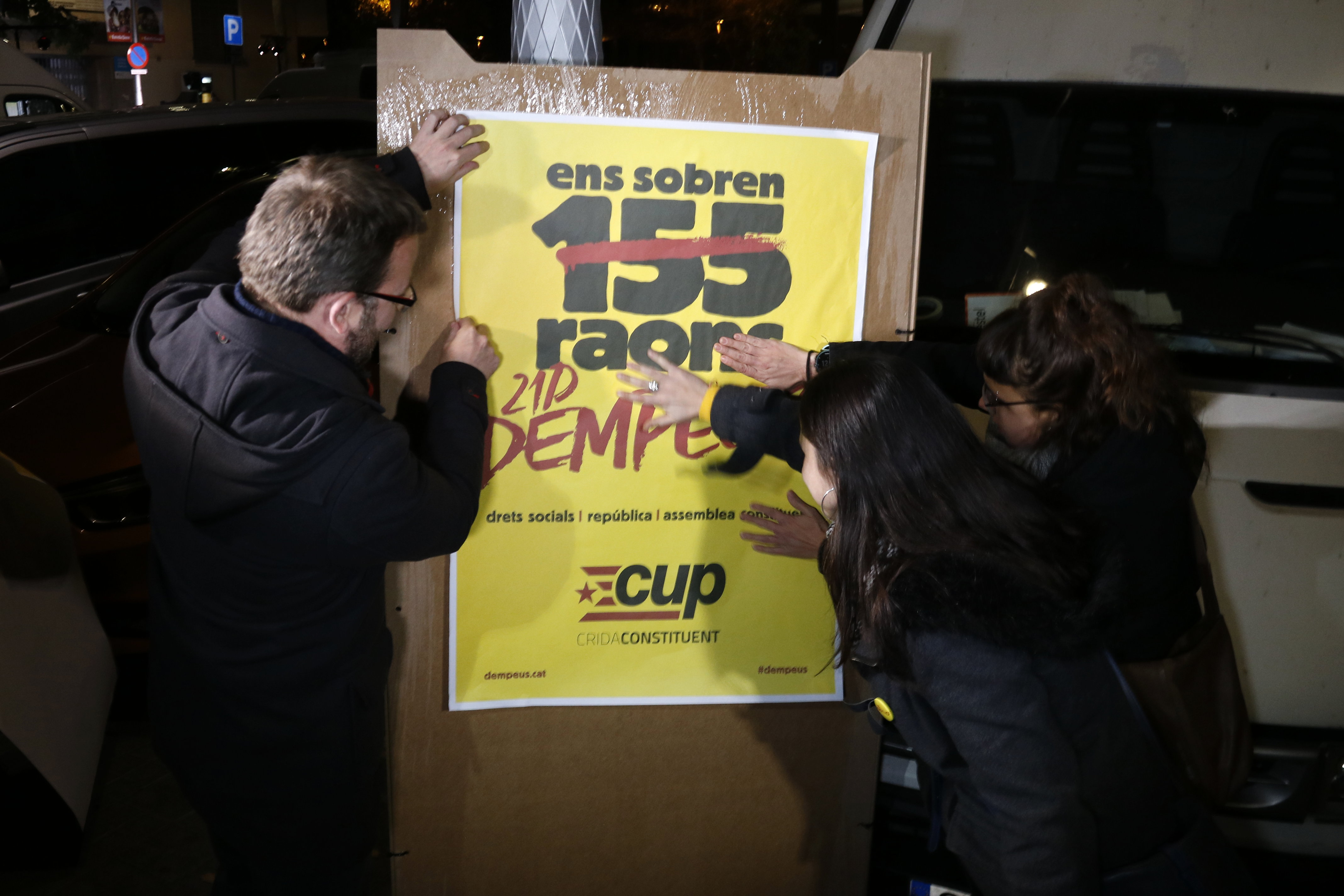 The main CUP candidates with a poster rejecting Article 155 of the Constitution