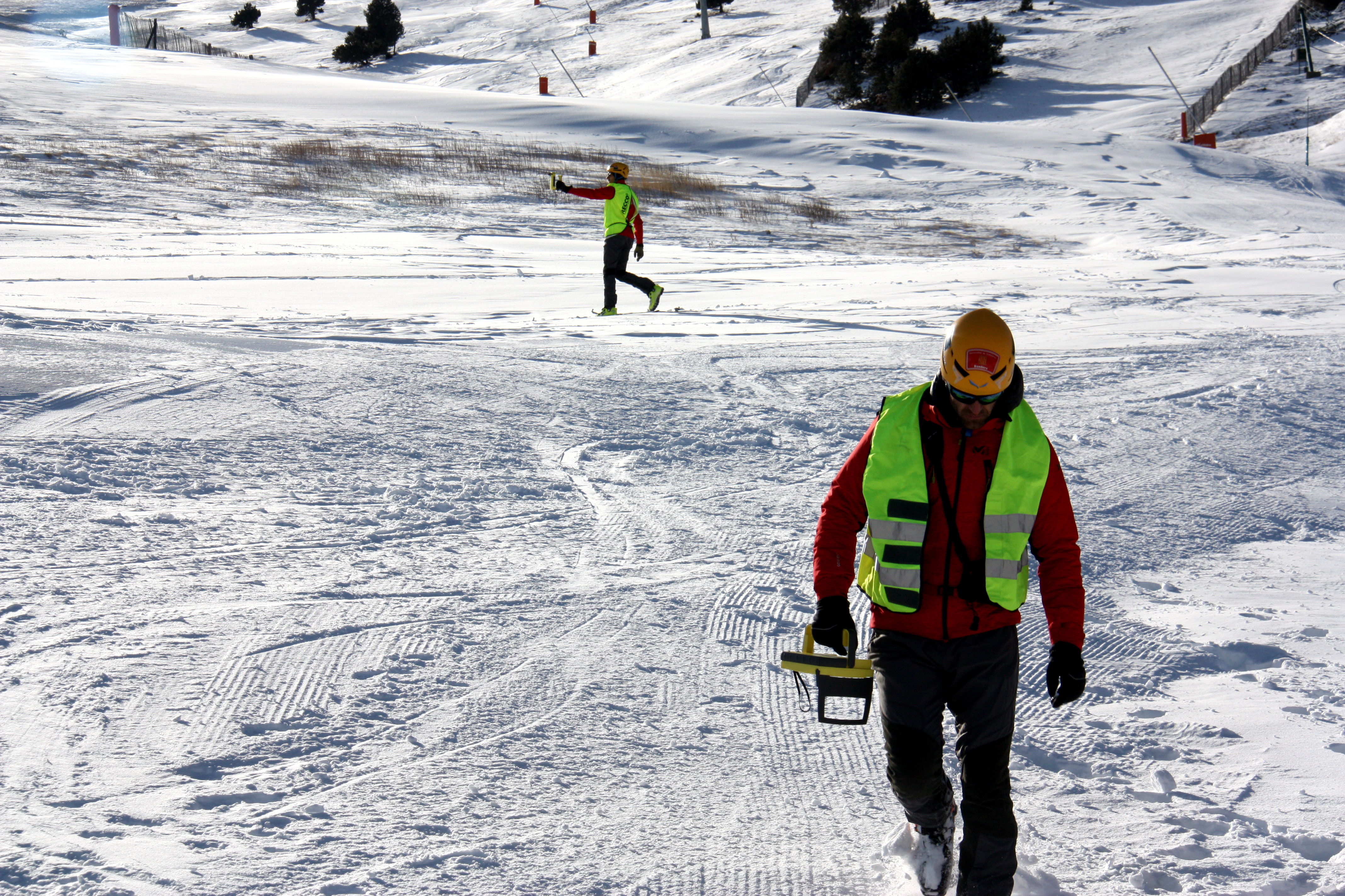 Firefighters using avalanche victim detection equipment
