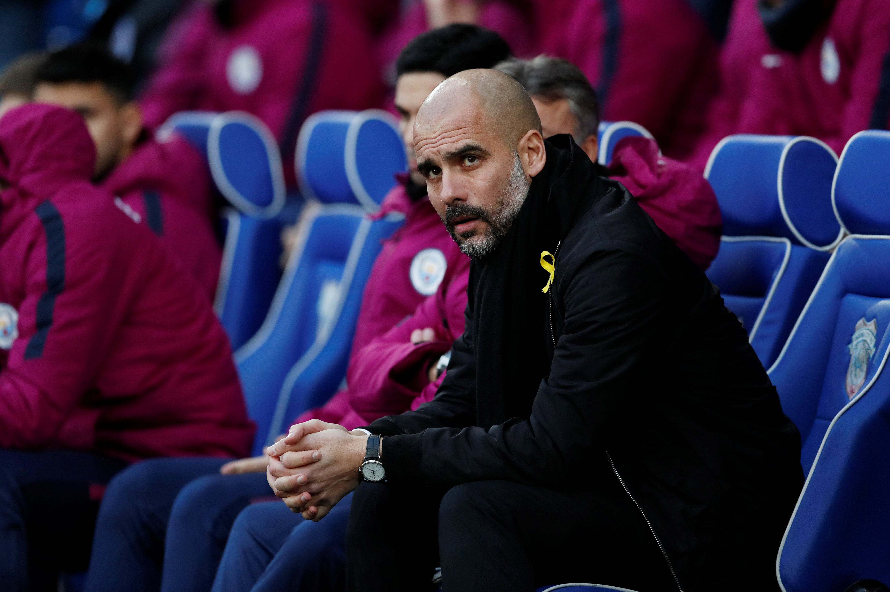 Football coach Pep Guardiola wearing a yellow ribbon (by Reuters/Andrew Boyers)
