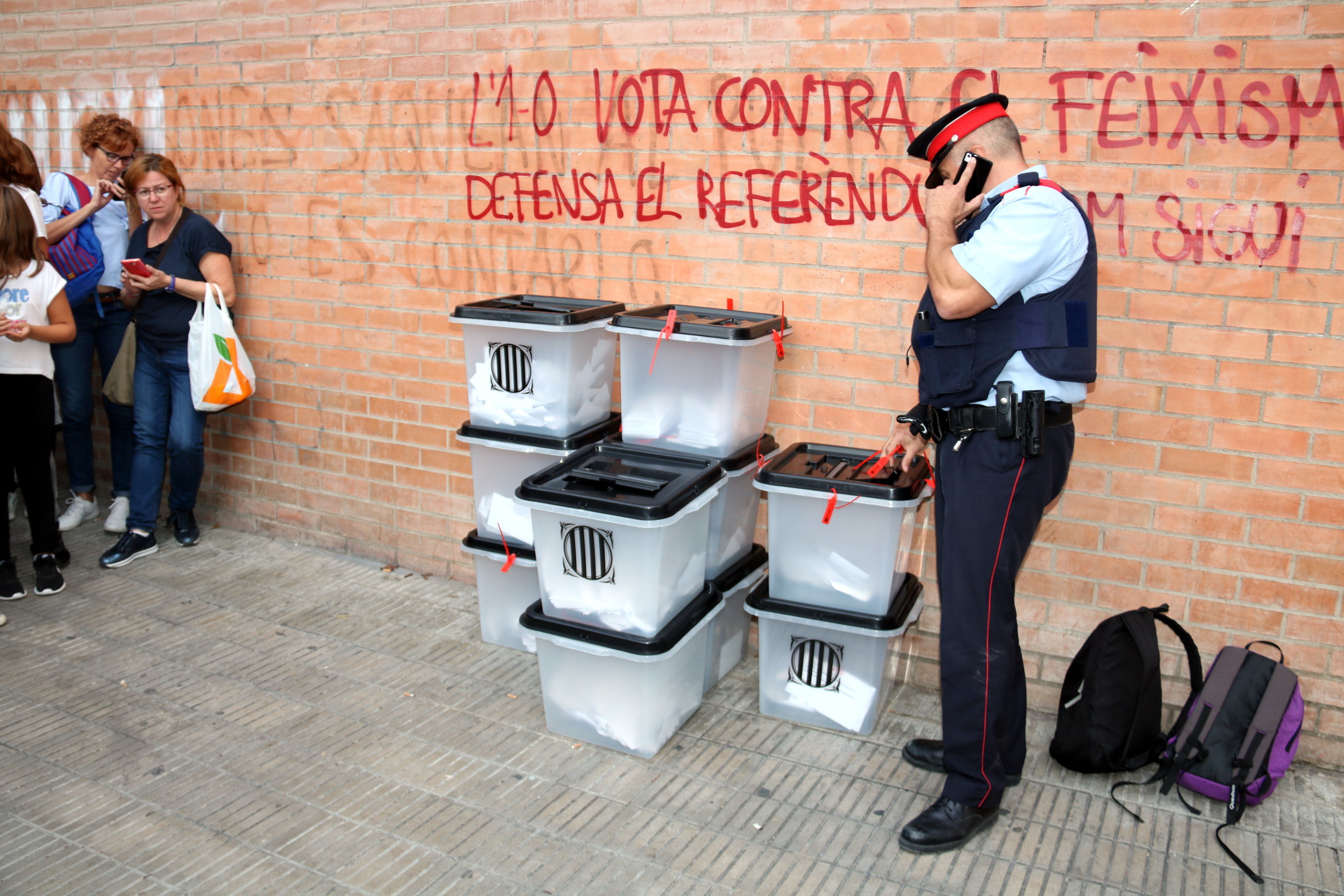 A Catalan police officer looking over some ballot boxes in Lleida (by Salvador Miret)