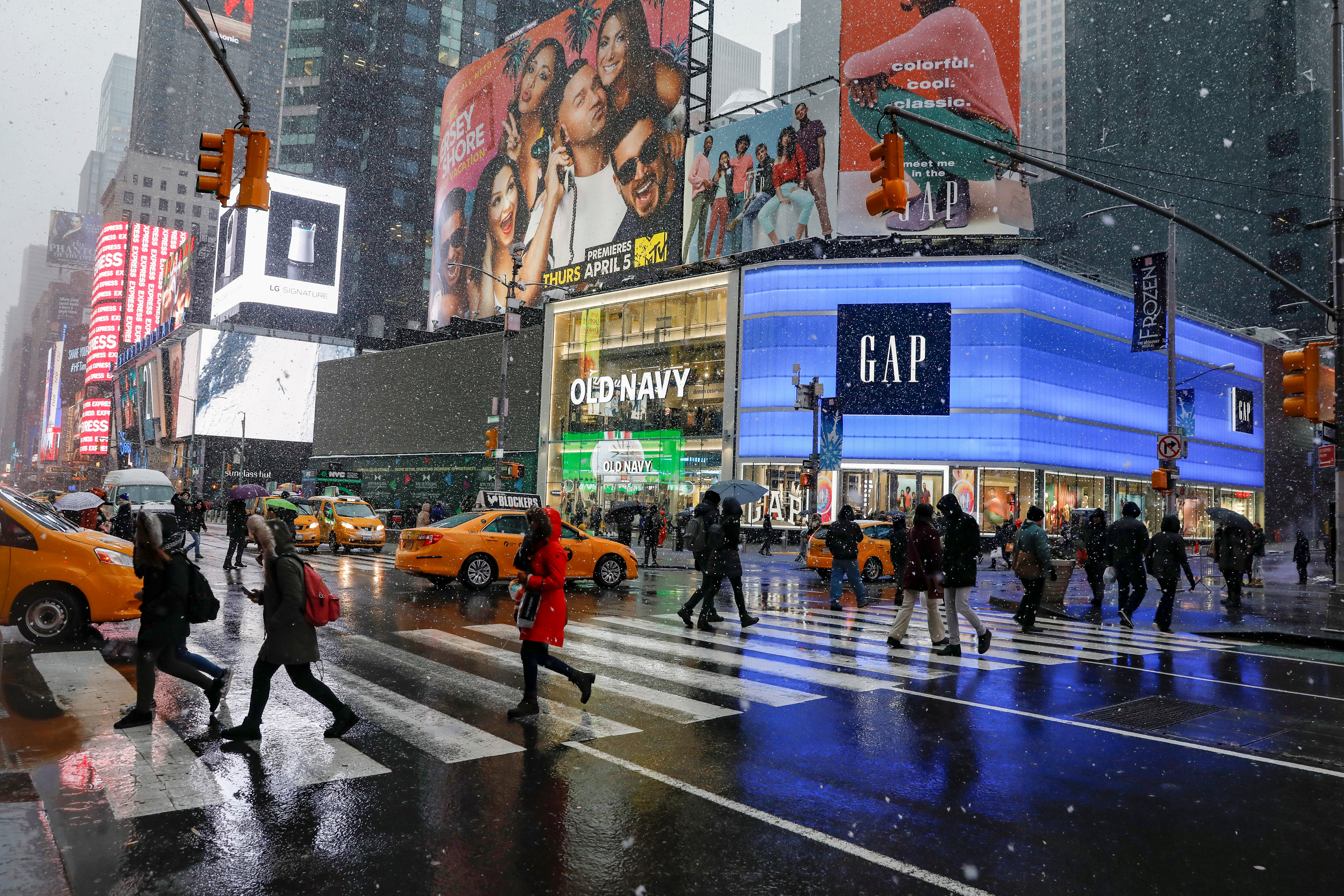 People in the rain at Times Square, New York (courtesy of Reuters)