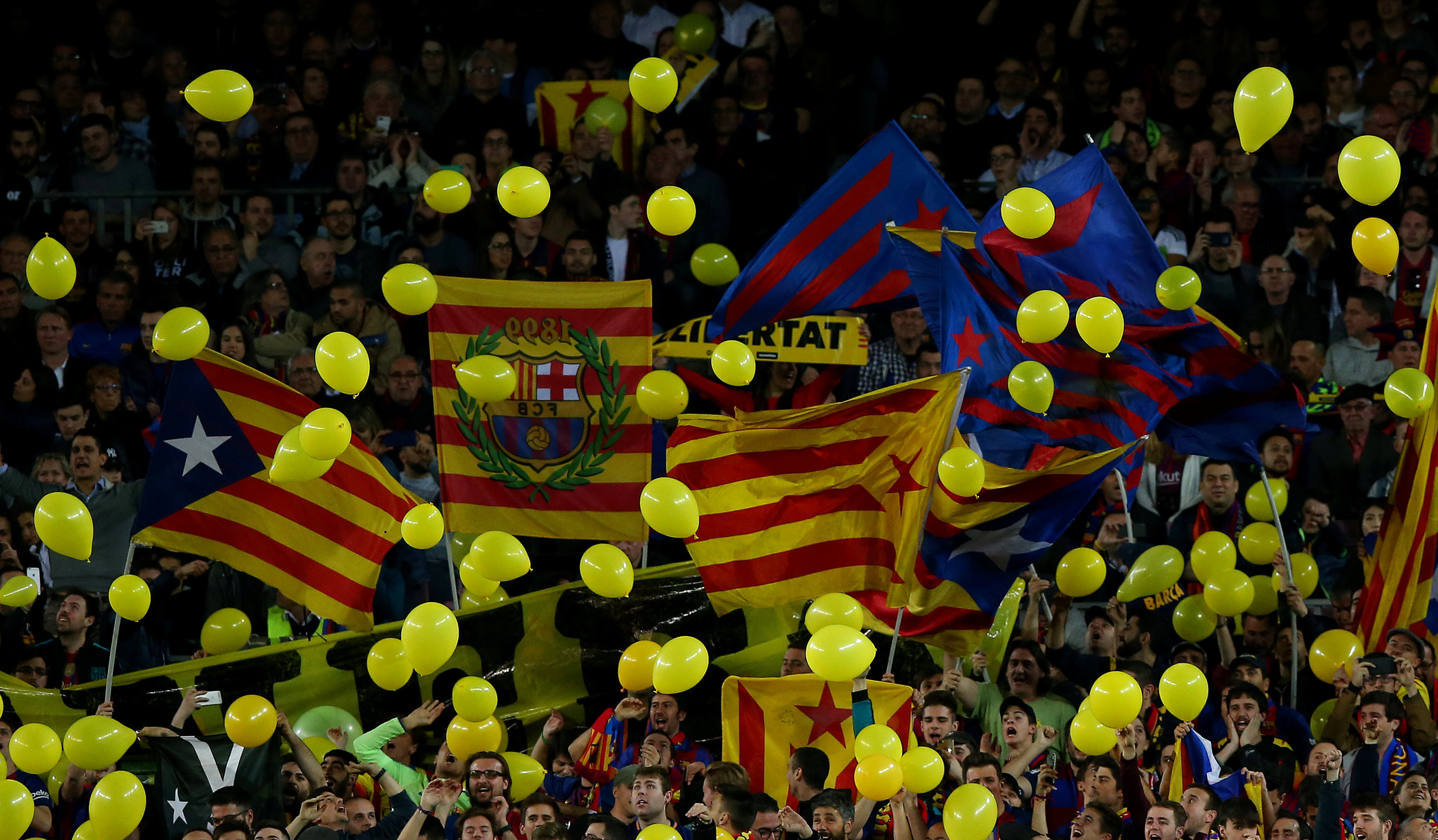 Barça fans throw yellow balloons onto the pitch at Camp Nou (courtesy of Reuters)