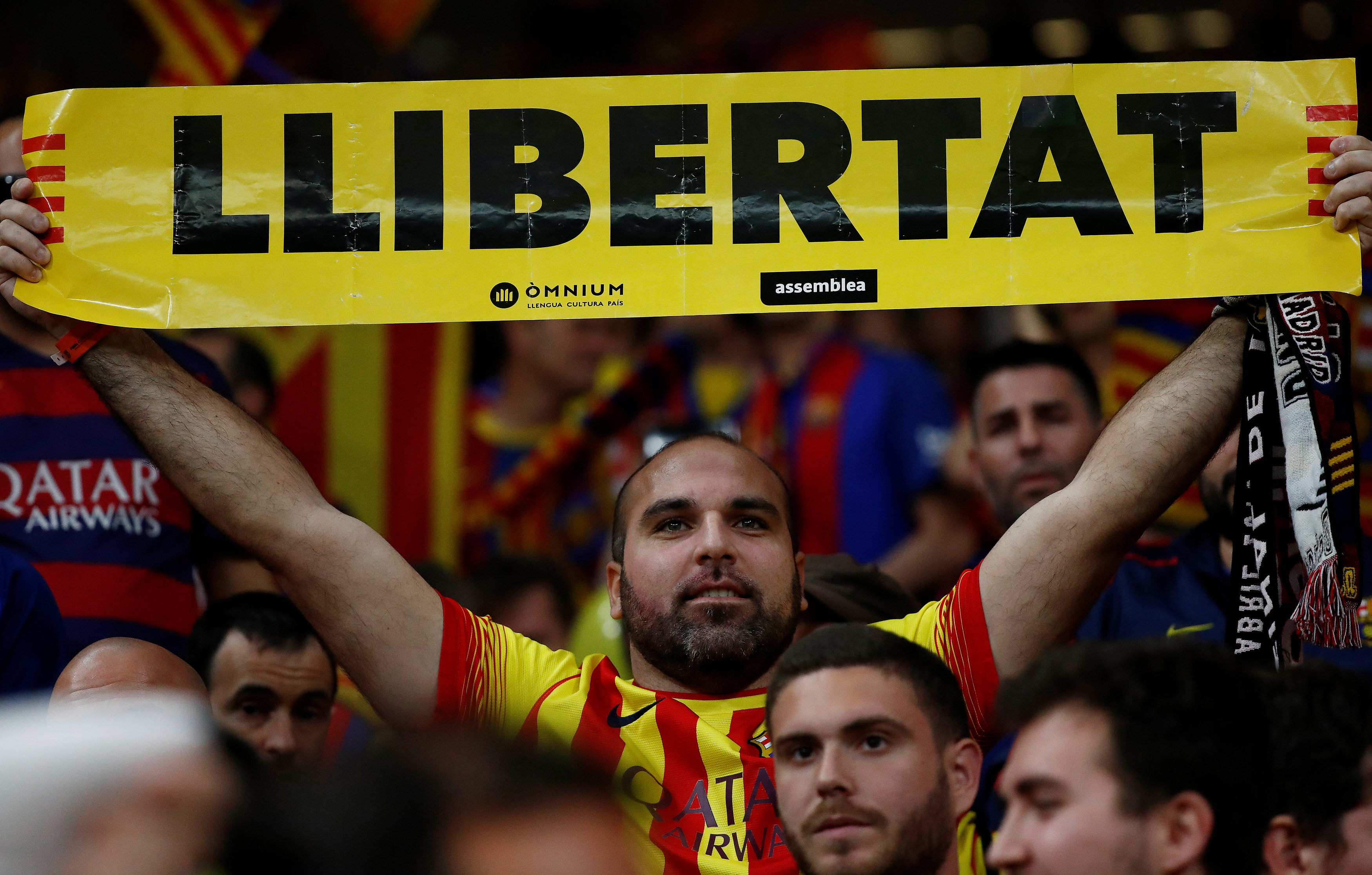 Barcelona fan holds up a “Llibertat” banner before the match (Courtesy of REUTERS/Juan Medina)
