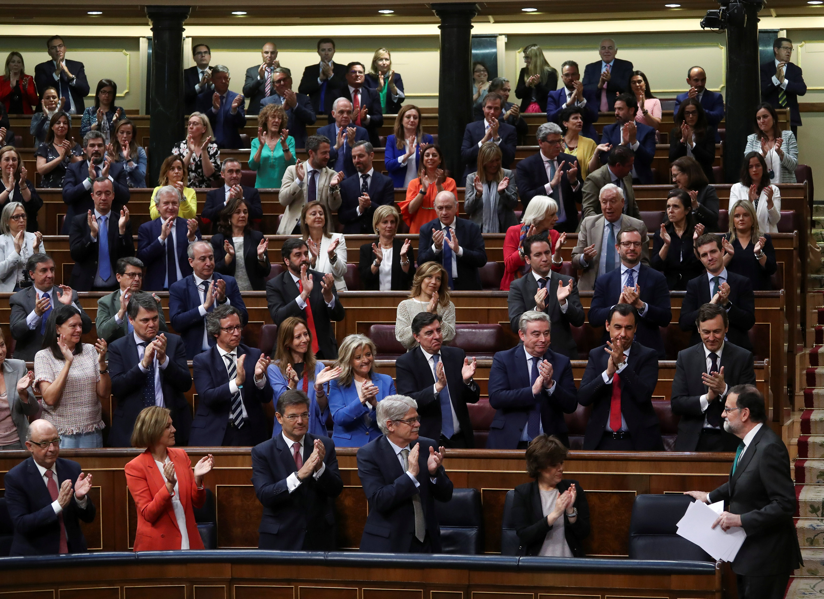 Spain's Prime Minister Mariano Rajoy is applauded by party members during a motion of no confidence debate at Parliament in Madrid (REUTERS/Sergio Perez)