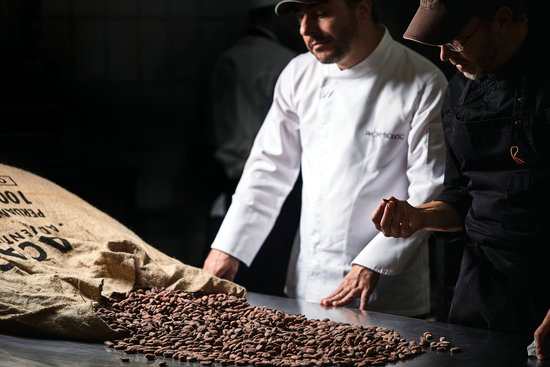 Jordi Roca and chocaltier Damian Allsop contemplating cocoa beans (courtesy of Celler de Can Roca)