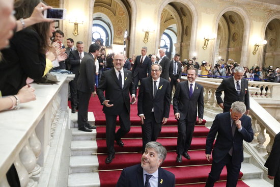 Quim Torra (center) leaving the Catalan parliament after being elected as president (by ACN)