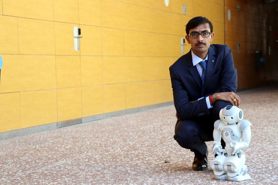 Researcher Jainendra Shukla with the robot aiming to improve treatment for autistic children and dementia sufferers (by Rovira i Virgili University)