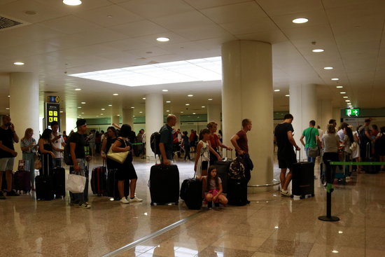Some passengers in a line at Barcelona airport in July 2018 (by Laura Fíguls)