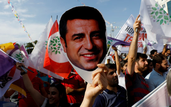 An image of a demonstration of HDP Kurdish party with a mask of Selahattin Demirtas (by Reuters).