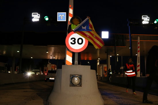 Image of a CDR activist next to a toll barrier in L'Hospitalet de l'Infant, southern Catalonia, on December 9, 2018 (by Mar Rovira)