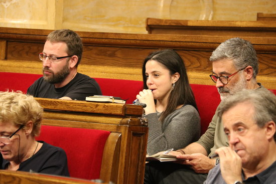 Members of far-left party CUP, Vidal Aragonès, Maria Sirvent and Carles Riera, sitting in Parliament