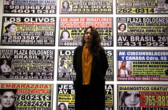 Artist Laia Abril standing in front of one part of her new exhibit in Foto Colectania, 'On Abortion'