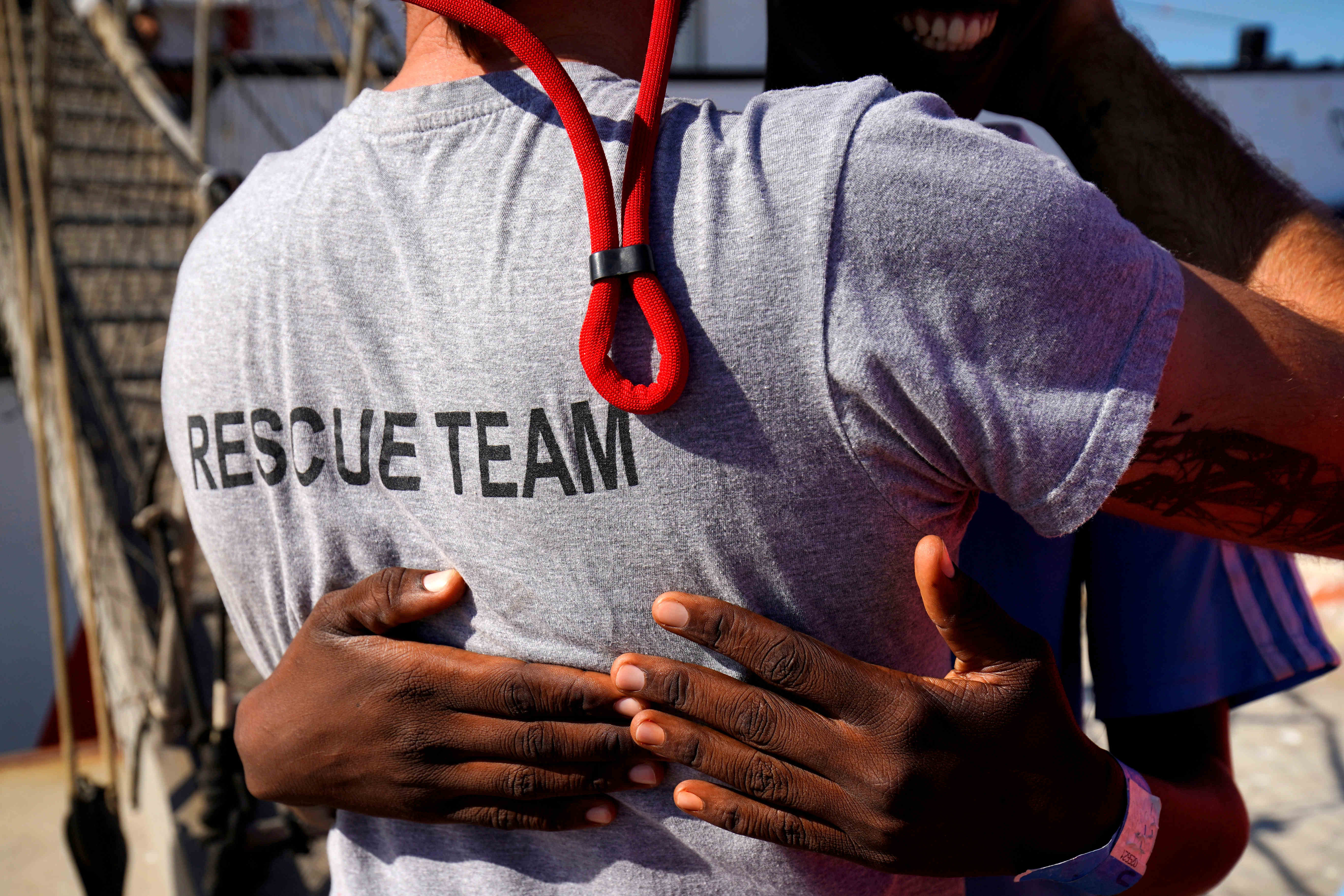 A migrant rescued by NGO Open Arms embraces Head Mission, Riccardo Gatti, after arriving at the port of Algeciras in San Roque (by REUTERS/Juan Medina)