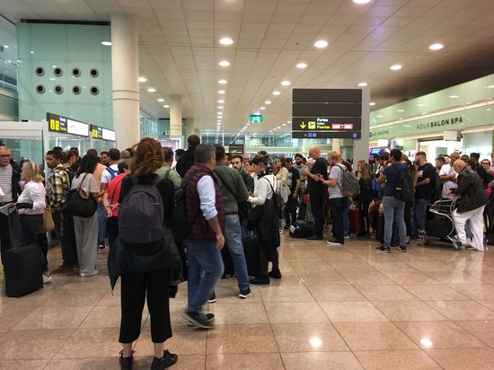 Passengers affected by protests at Barcelona airport queue up for information (by Xavi Toscano)