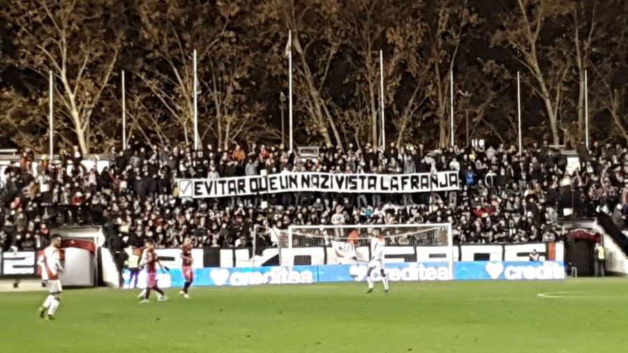 Rayo Vallecano ultras hold up a banner celebrating the fact that they avoided that Roman Zozulya ever played for their club (by Bukaneros)