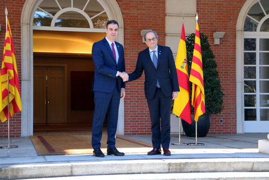 Spanish president Pedro Sánchez shakes hands with Catalan president Quim Torra ahead of the first 'negotiation table' meeting between the two governments, in February 2020 (by Gemma Tubert)