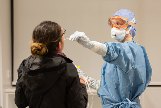 A healthcare worker performs a coronavirus test on a person (image by Francisco Avia, Hospital Clínic de Barcelona)