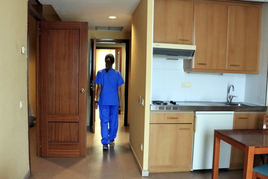 A doctor in a room of the Hotel Hesperia, converted into an emergency hospital assisting covid-19 coronavirus patients (by Laura Fíguls)