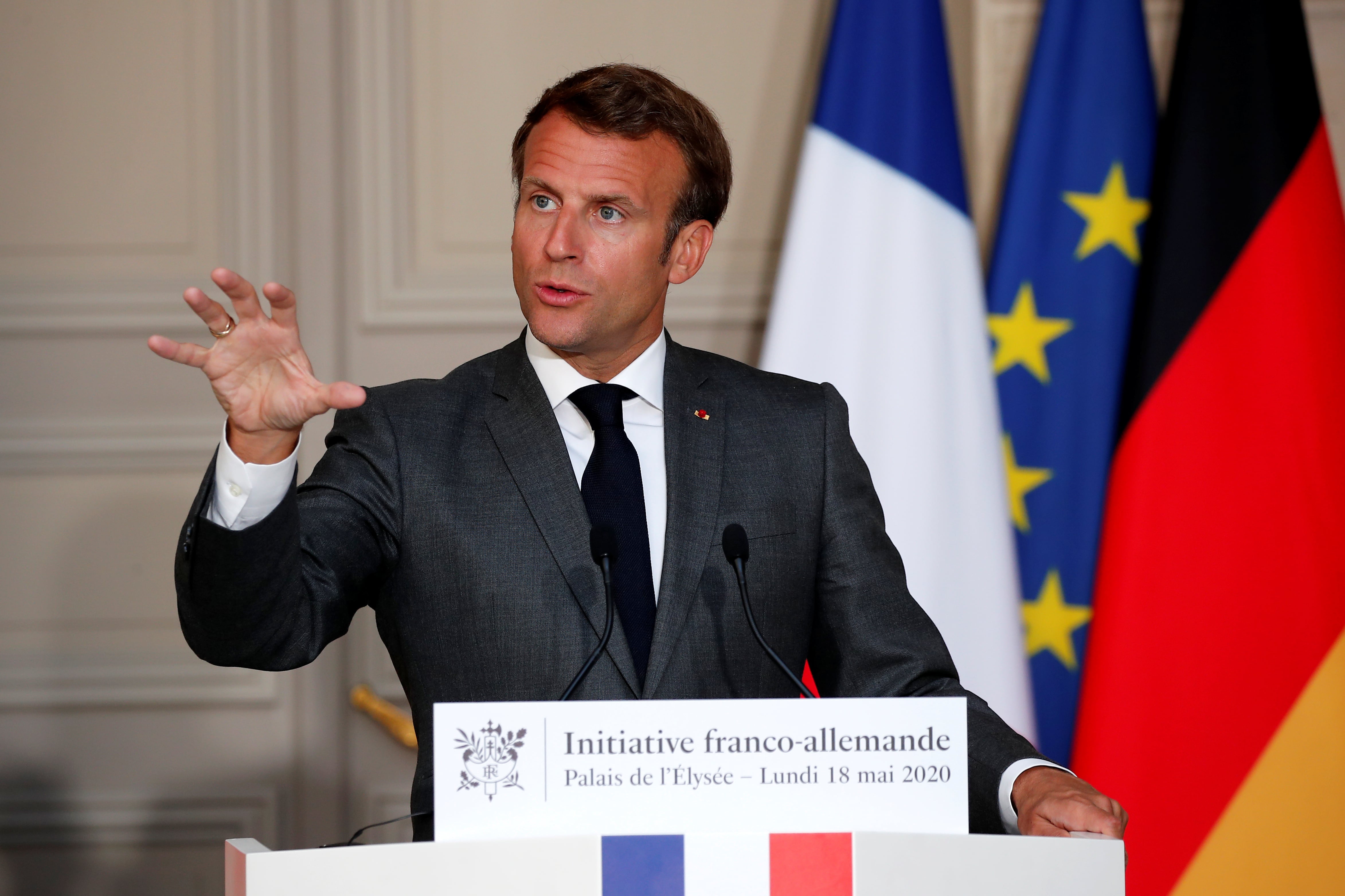 Emmanuel Macron speaks at a joint video news conference with German Chancellor Angela Merkel to discuss Europe's economic recovery plans (by Francois Mori/REUTERS)