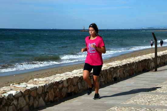 A woman runs along a seafront promenade in Altafulla, May 2, 2020 (by Mar Rovira)