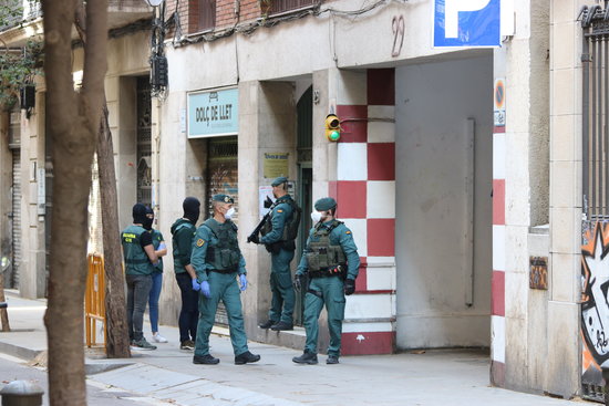 Guardia Civil police officers stand outside the home of an alleged radical plotting a terrorist attack who was arrested on Friday, May 8, 2020 (by Miquel Codolar)