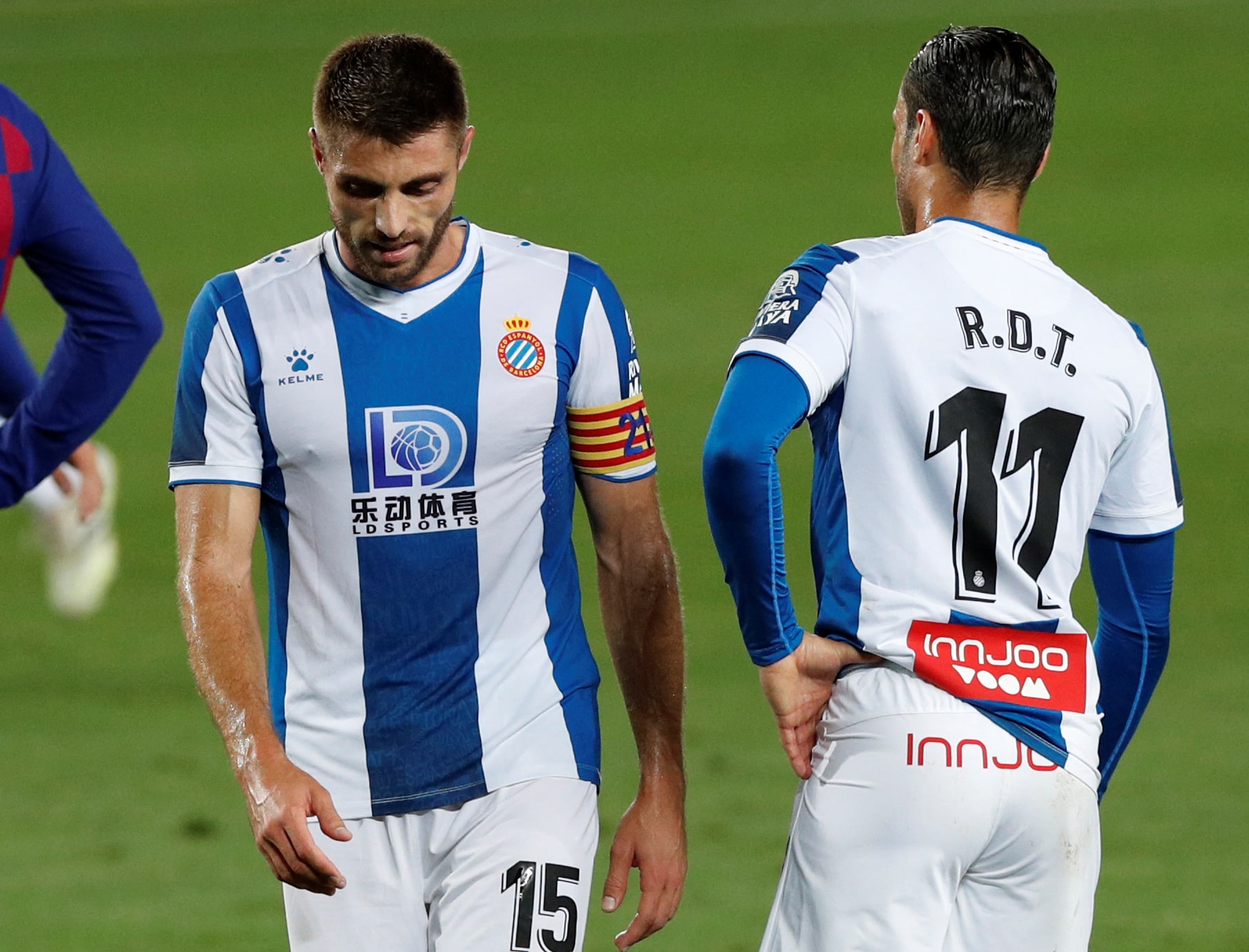 Espanyol's David López and Raúl de Tomás dejected as Espanyol lose to Barcelona, sealing their relegation to the second division (by REUTERS/Albert Gea)