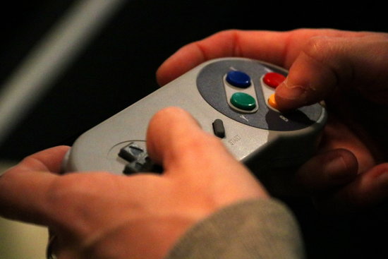 A person plays a video game during CCCB's Gameplay exhibition, December 18, 2019 (by Mar Vila)