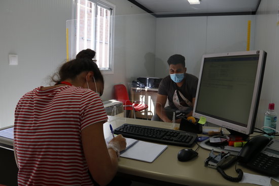 The seasonal worker who only gave his name as Mohamed sits in the services office of the Fira de Lleida congress hall (by Laura Cortés) 