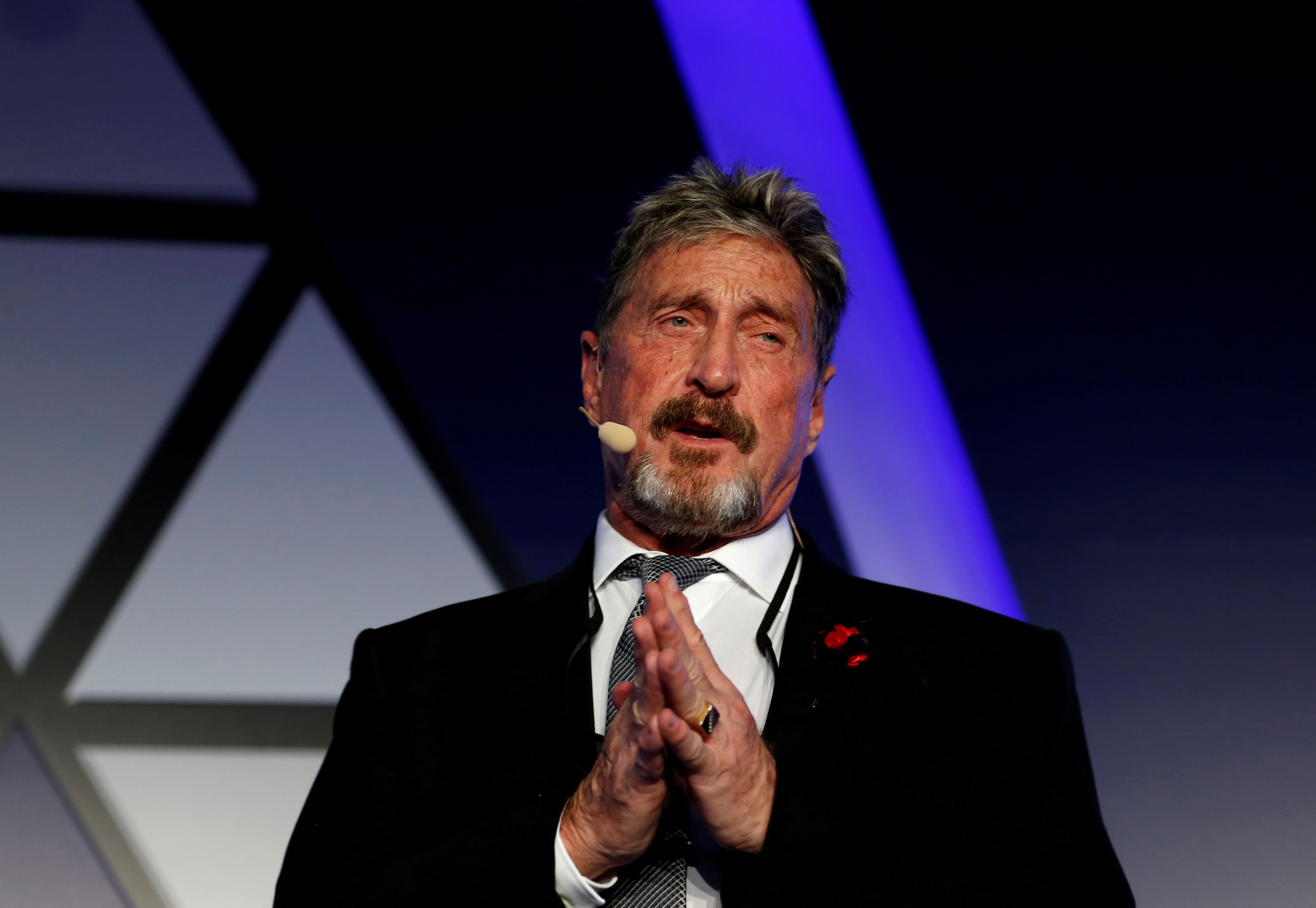 John McAfee, founder of McAfee Antivirus software company, speaks at an industry summit in 2018 (REUTERS/Darrin Zammit Lupi/File Photo)