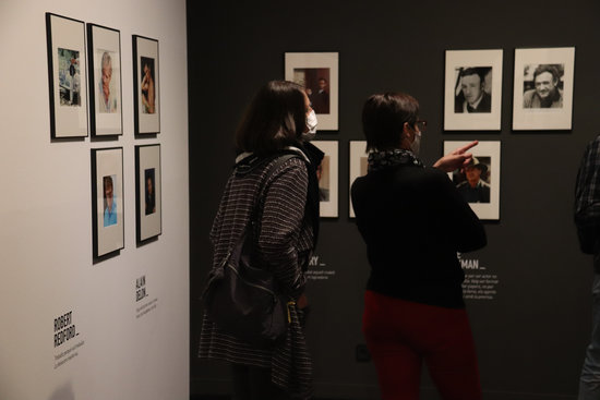 Two visitors look at photographs on display at Girona's Cinema Museum (by Aleix Freixas)