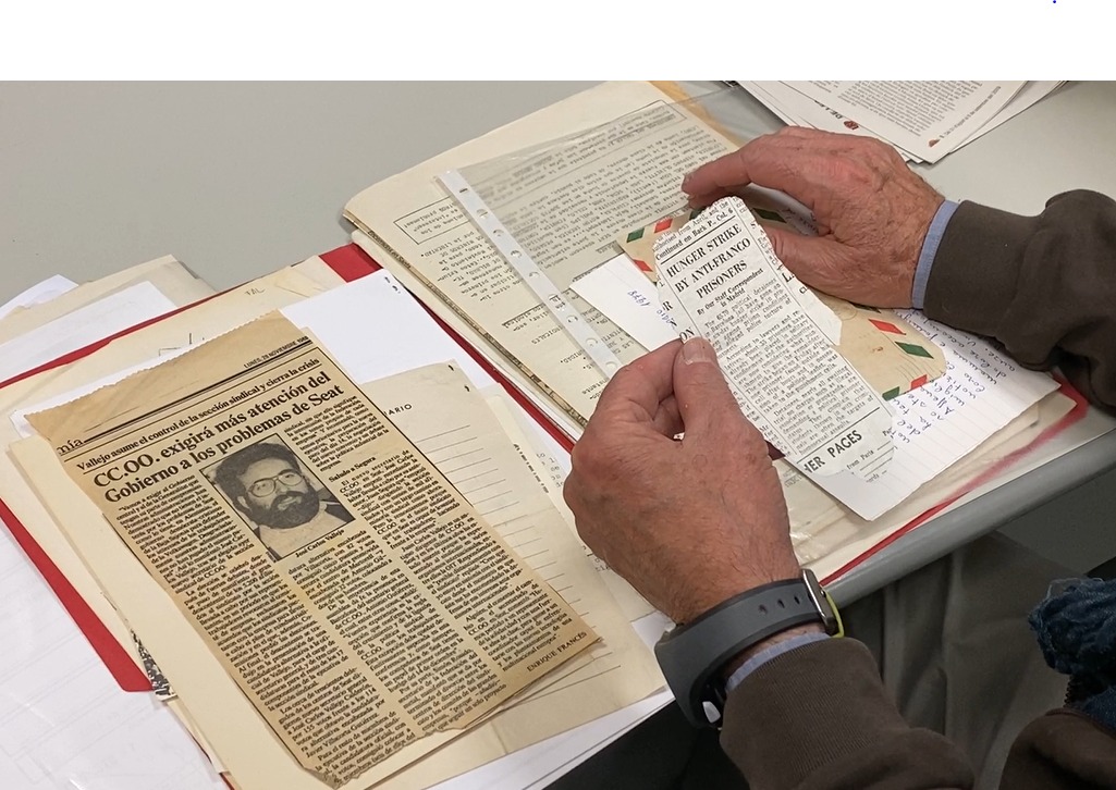 Carles Vallejo, president of the association of former political prisoners of Francoism, looks through old newspaper clippings of stories related to his time in prison (by Cristina Tomàs White)